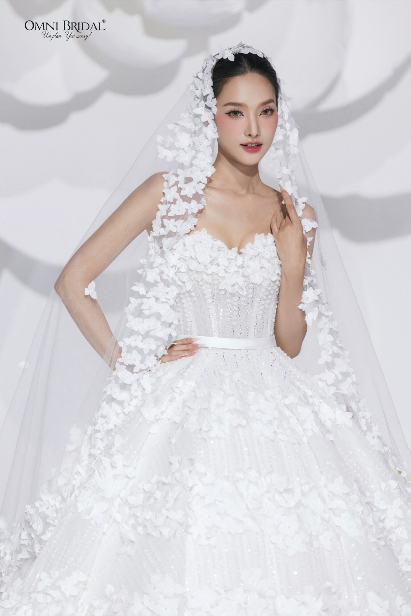 Chiếc váy có hoa tiết 3D tạo nên hiệu ứng cân bằng cho nàng dâu thêm tự tin tỏa sáng. 